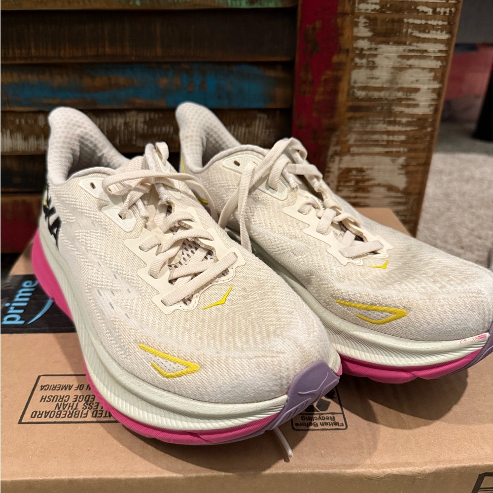 HOKA shoes white, pink, and yellow.
